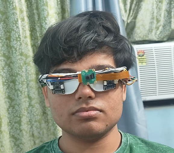 Divya Drishti prototype: assistive glasses with camera, ToF sensors and near-eye displays, worn during bring-up.